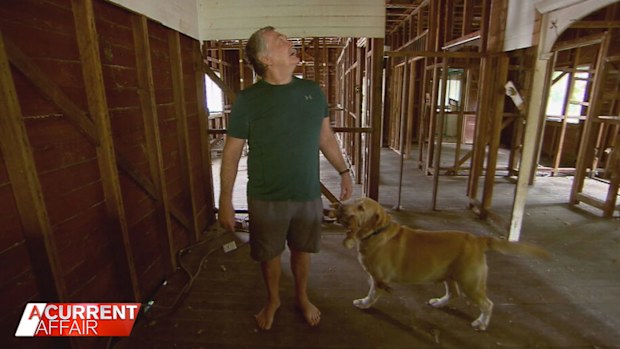 Retiree Glen Lewis inside his flood-wrecked home.
