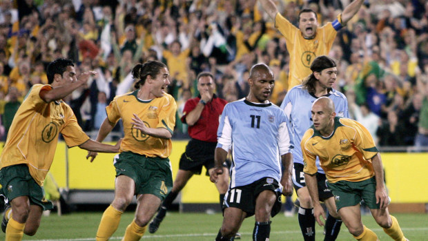 Australian players Tim Cahill, Harry Kewell, Mark Viduka (back right) celebrate after teammate Marco Bresciano scored against Uruguay in their World Cup qualifier in Sydney, 2005.