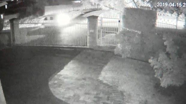 CCTV of a light-coloured car near the scene of the shooting.
