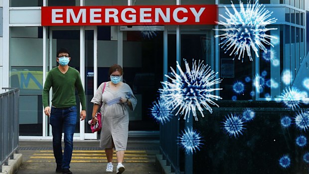 Two people wearing face masks walk out of the emergency entrance at Westmead Hospital, in Sydney's west.