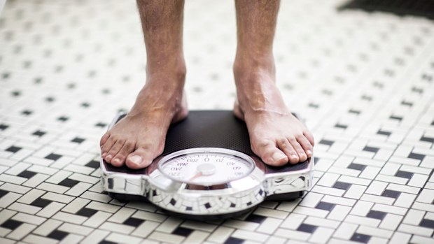 Man weighing himself