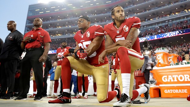 San Francisco 49ers safety Eric Reid (left) and quarterback Colin Kaepernick kneel during the national anthem before a 2016 NFL football game against the Los Angeles Rams.