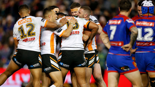 Wests Tigers celebrate after defeating the Newcastle Knights 28-26