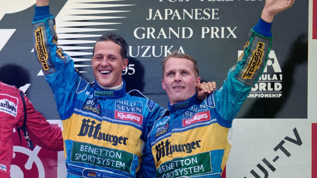 CROPPED: Michael Schumacher of Germany and driver of the #1 Mild Seven Benetton Renault Benetton B195Renault RS7 V10 celebrates with third placed team mate Johnny Herbert ( R ) after winning the Japanese Grand Prix on 29 October 1995 at the Suzuka Circuit, Suzuka, Japan. (Photo by Pascal Rondeau/Allsport/Getty Images)