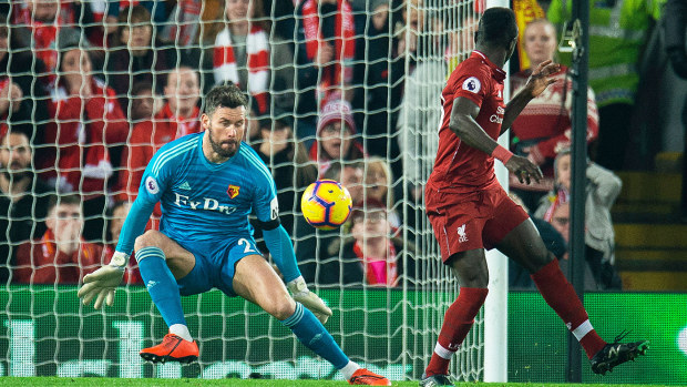 Liverpool's Sadio Mane (R) scores