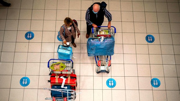 People wait at OR Tambo's airport in Johannesburg, in South Africa. The Omicron variant has become the most dominant strain circulating South Africa.