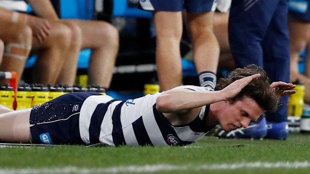 Max Holmes slaps the ground in frustration after coming from the field injured.