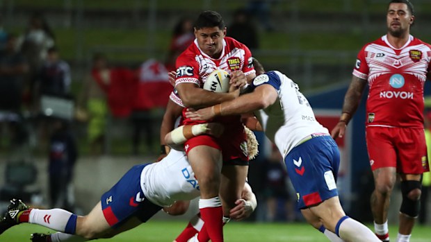 Jason Taumalolo captain of Tonga is tackled (C) during the International Rugby League Test match between the Great Britain Lions and Mate Ma'a Tonga 