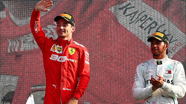 Race winner Charles Leclerc of Monaco and Ferrari is applauded by third placed Lewis Hamilton 