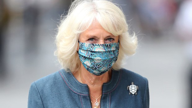 Camilla, Duchess of Cornwall wears a mask with a feather design on July 28, 2020 in London, England