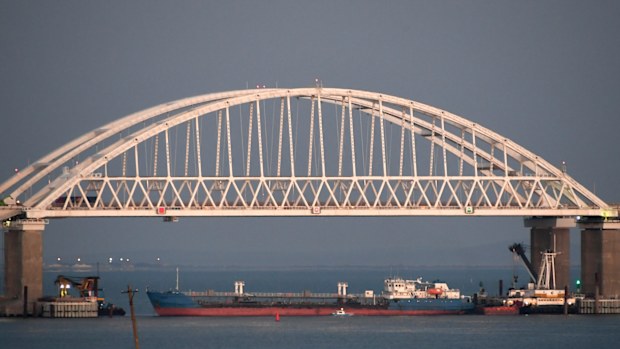 A Russian tanker under the the Kerch bridge blocks the passage to the Kerch Strait near Kerch, Crimea. The Ukrainian Security Service (SBU) said in a statement Thursday July 25, 2019, that it has seized the Russian tanker moored in a Ukrainian Black Sea port. (AP Photo)