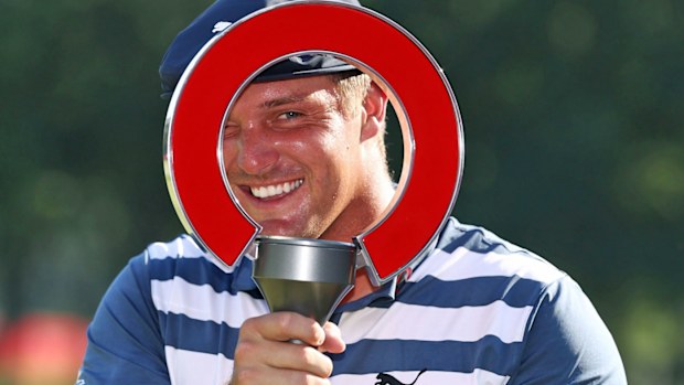 Bryson DeChambeau of the United States celebrates with the trophy