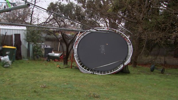 A trampoline was upended in a backyard in the wild weather.
