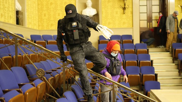 A protester spotted inside the Senate chamber carrying plastic zip-tie handcuffs has prompted theories some in the Capitol riot wanted to catch and detain hostages.