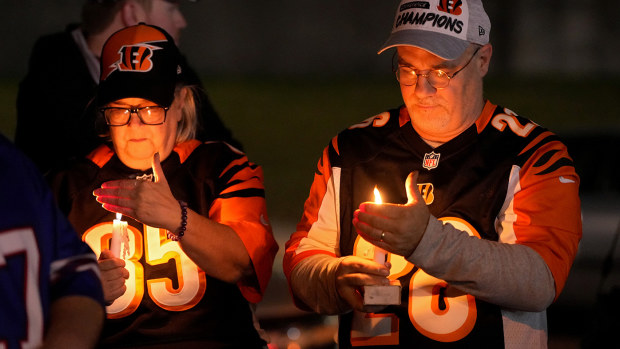 Fans gather for a vigil at the University of Cincinnati Medical Center for football player Damar Hamlin.