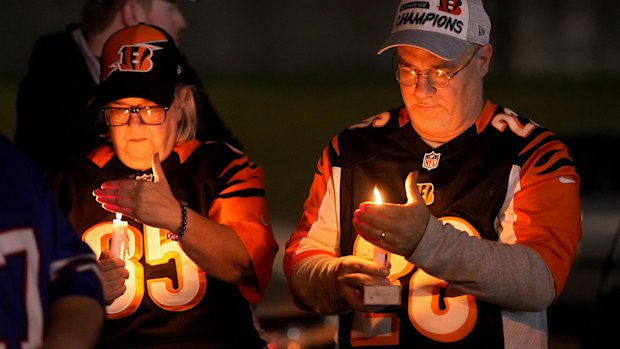 Fans gather for a vigil at the University of Cincinnati Medical Center for football player Damar Hamlin.