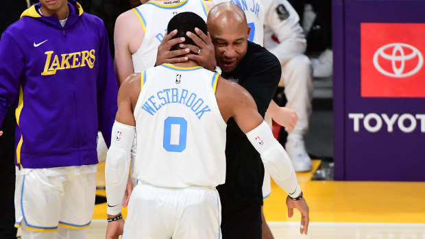 Lakers coach Darvin Ham and Russell Westbrook share an embrace after the win over Denver