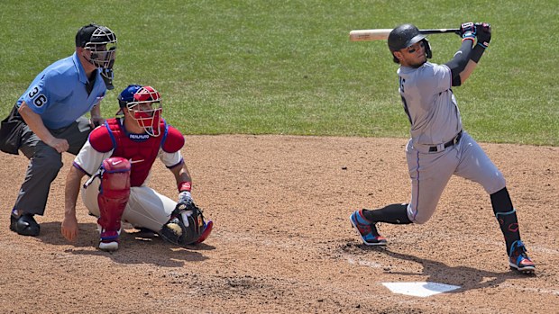 Miguel Rojas #19 of the Miami Marlins hist an RBI triple in the top of the fourth inning against the Philadelphia Phillies 