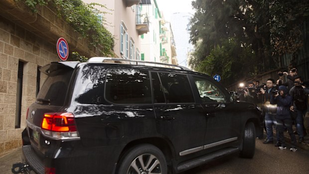 Journalists film a vehicle leaving the home of former Nissan Chairman Carlos Ghosn in Beirut, Lebanon, Thursday, Jan. 2, 2020. Turkish authorities have detained seven people as part of an investigation into how Ghosn, who skipped bail in Japan, was able to flee to Lebanon via Istanbul, Turkish media reported Thursday. 