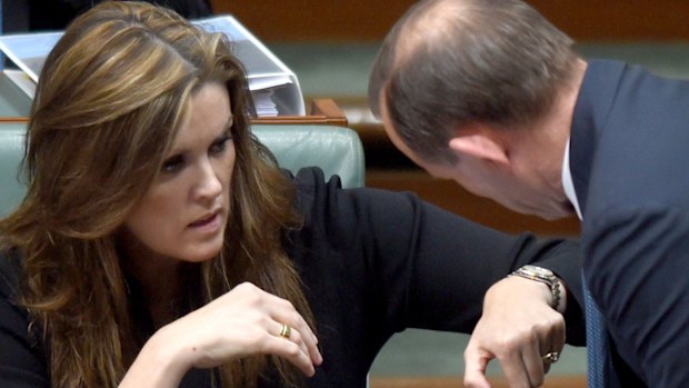 Tony Abbott speaks with his chief of staff Peta Credlin in parliament. (AAP)