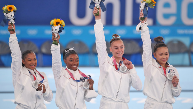 The United States team with their silver medals on the podium, Jordan Chiles, Simone Biles, Grace. McCallum and Sunisa Lee
