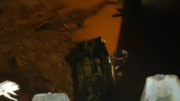 The car fell into the vacant construction site after a collision at a nearby intersection.