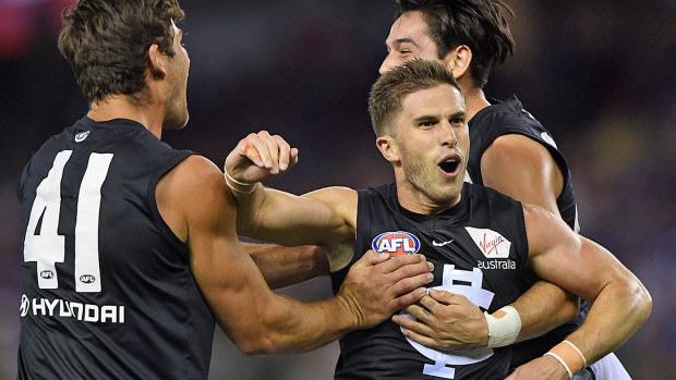 Marc Murphy of the Blues (centre) reacts after kicking a goal 
