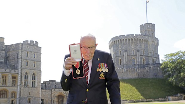 Captain Sir Thomas Moore poses after being awarded with the insignia of Knight Bachelor by Queen Elizabeth II at Windsor Castle on July 17, 2020 in Windsor, England.