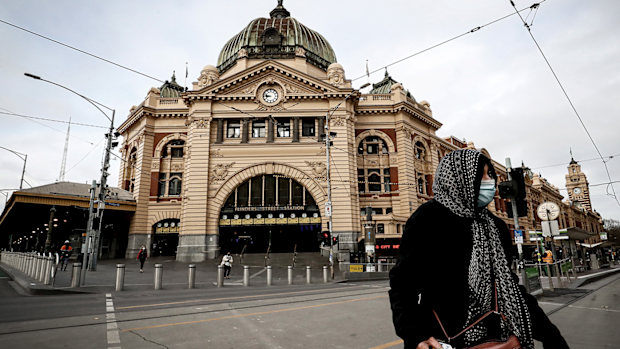 A woman is seen wearing a face mask out Flinders Street Station on July 23, 2020 in Melbourne, Australia. 
