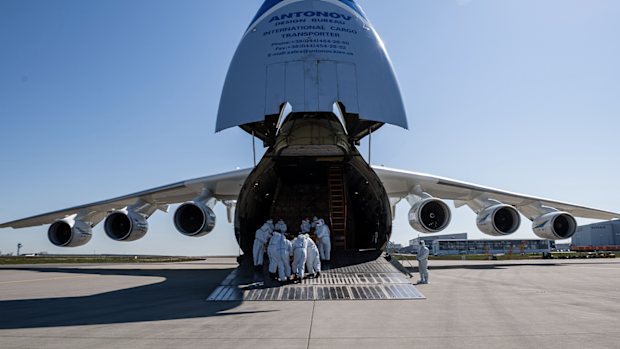 Workers unload a shipment of 10 million protective face masks and other protective medical gear that had arrived on an Antonov 225 cargo plane from China at Leipzig/Halle Airport during the novel coronavirus crisis on April 27, 2020 in Schkeuditz, Germany.