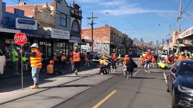 Construction workers block off Sydney Road in Brunswick as part of their protest.