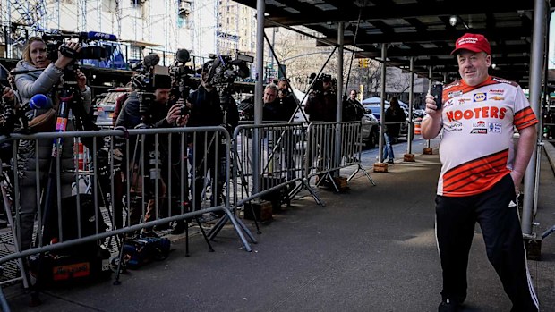 A lone Trump supporter heckles the media outside the building where a grand jury is meeting.