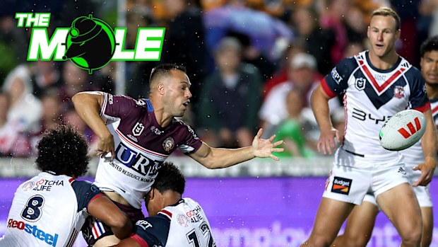 Luke Brooks of Manly loses the ball in front of Roosters halfback Daly Cherry-Evans.