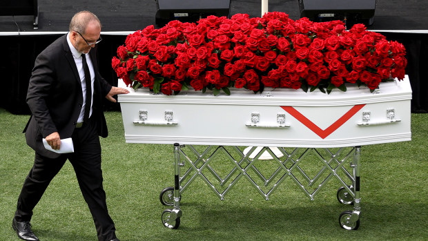 Stuart Raper places a hand on his father's casket during the State Funeral for Rugby League Immortal John Raper at Sydney Cricket Ground on February 28, 2022 in Sydney, Australia.