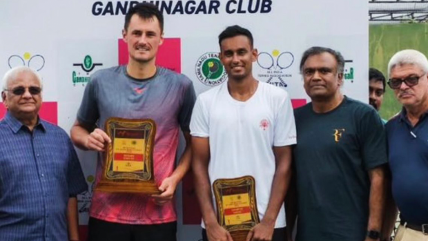 Bernard Tomic poses with his trophy after taking out the ITF M25 Chennai tournament.