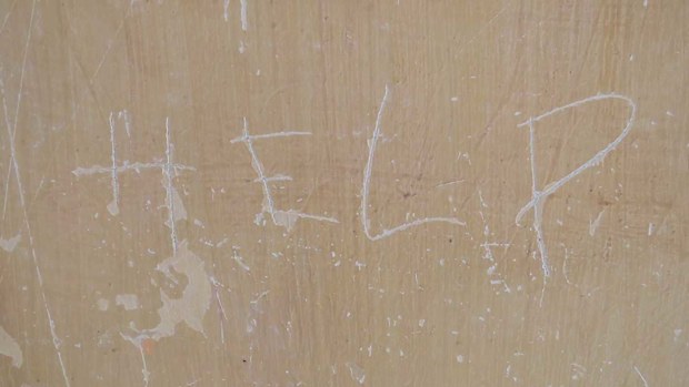 An ominous cry for help scrawled on the wall from an English-speaking prisoner.
