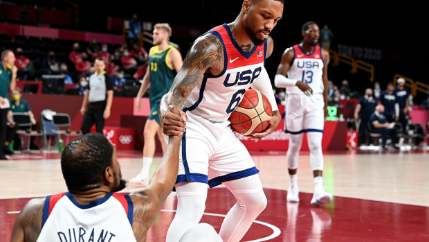 Damian Lillard gives team mate Kevin Durant of the USA a helping hand during the Basketball semi final match between Australia and the USA on day thirteen of the Tokyo 2020 Olympic Games at Saitama Super Arena on August 05, 2021 in Saitama, Japan. (Photo by Bradley Kanaris/Getty Images)