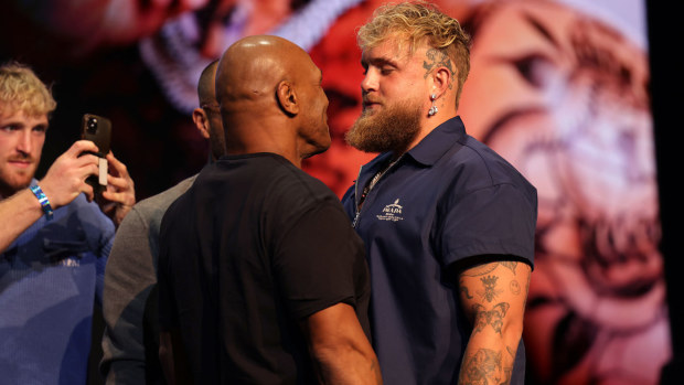 Mike Tyson shapes up to Jake Paul at a press conference.