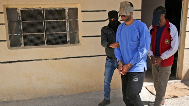 A Kurdish security officer escorts Alexanda Kotey, left, and El Shafee Elsheikh, who were allegedly among four British jihadis who made up a brutal Islamic State cell dubbed "The Beatles. (Image: AP)