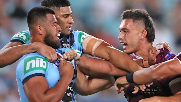 Tino Fa'asuamaleaui of the Maroons and Payne Haas of the Blues scuffle 