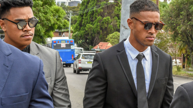 NRL player Michael Kam (right) and his younger brother Livingston Kam leave Waverly Local Court in February