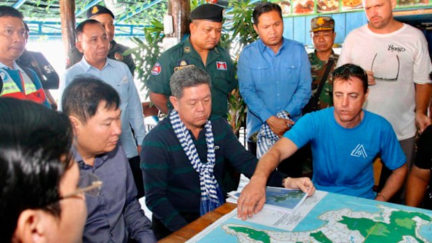 Sihanoukville provincial Governor Kuoch Chamroeun, center, looks at a map of Koh Rong where British national Amelia Bambridge went missing.