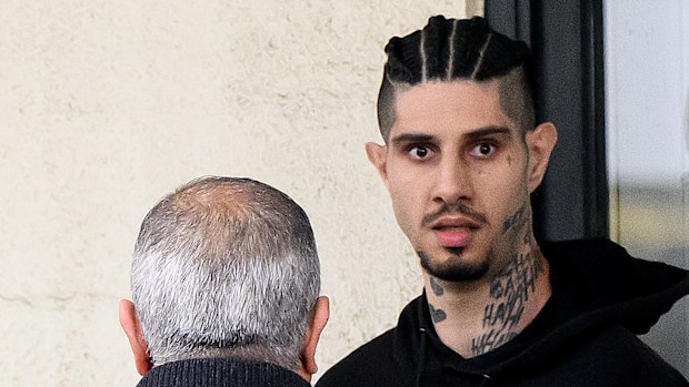 Issa Haddad (right) was spoken to by police after an altercation with media as he departed the Fairfield Local Court in Sydney.