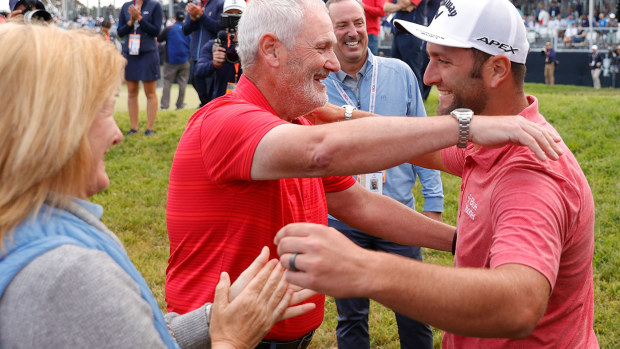 Jon Rahm of Spain celebrates with his father, Edorta Rahm (C), and mother, Ángela (L), after making a putt for birdie on the 18th green during the final round of the 2021 U.S. Open.