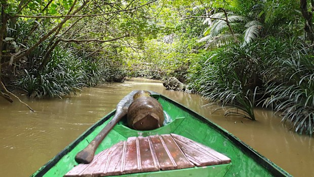 A boat journeys towards Liang Tebo cave in East Kalimantan.
