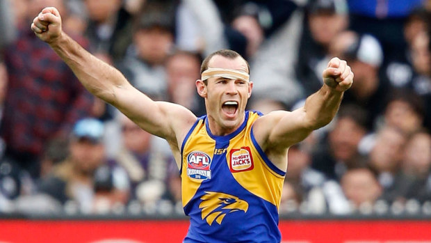 Shannon Hurn celebrates winning the 2018 grand final against Collingwood at the final siren