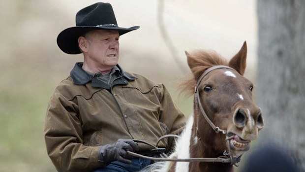 Roy Moore rides his horse to the polling station in Gallant, Alabama. (AAP)