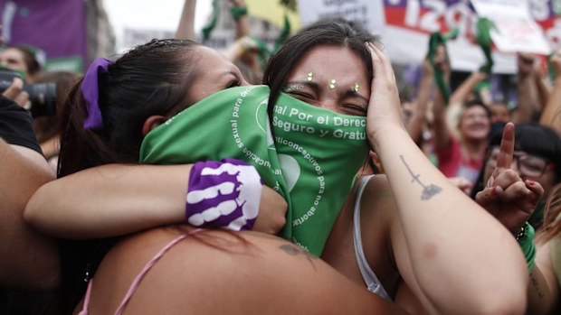 Abortion-rights activists celebrate as Argentine lower house approves a bill that would legalise abortion outside Congress in Buenos Aires, Argentina, Friday, Dec. 11, 2020