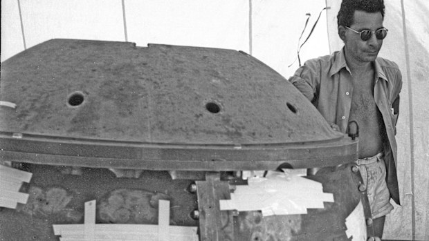 Louis Slotin standing next to "the gadget", better known as the first atomic bomb.