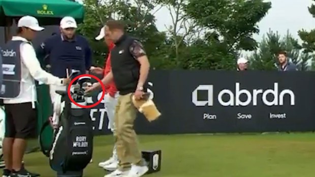 A spectator takes one of Rory McIlroy's clubs at the Scottish Open.